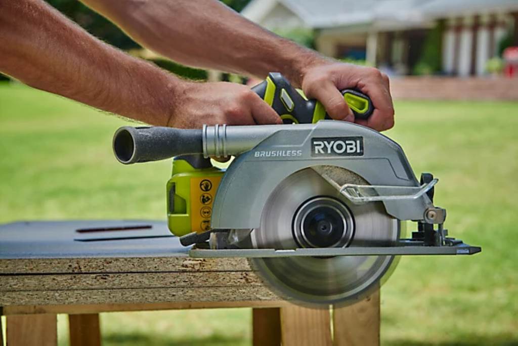 Assembled wooden birdhouse showcasing clean, straight edges from Ryobi 18V circular saw cuts on a sunny outdoor table.