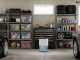 Garage dehumidifier with water collection bucket running in two-car garage with organized storage shelves
