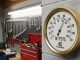 Hygrometer displaying humidity level of 45 percent mounted on garage wall near metal tools and equipment