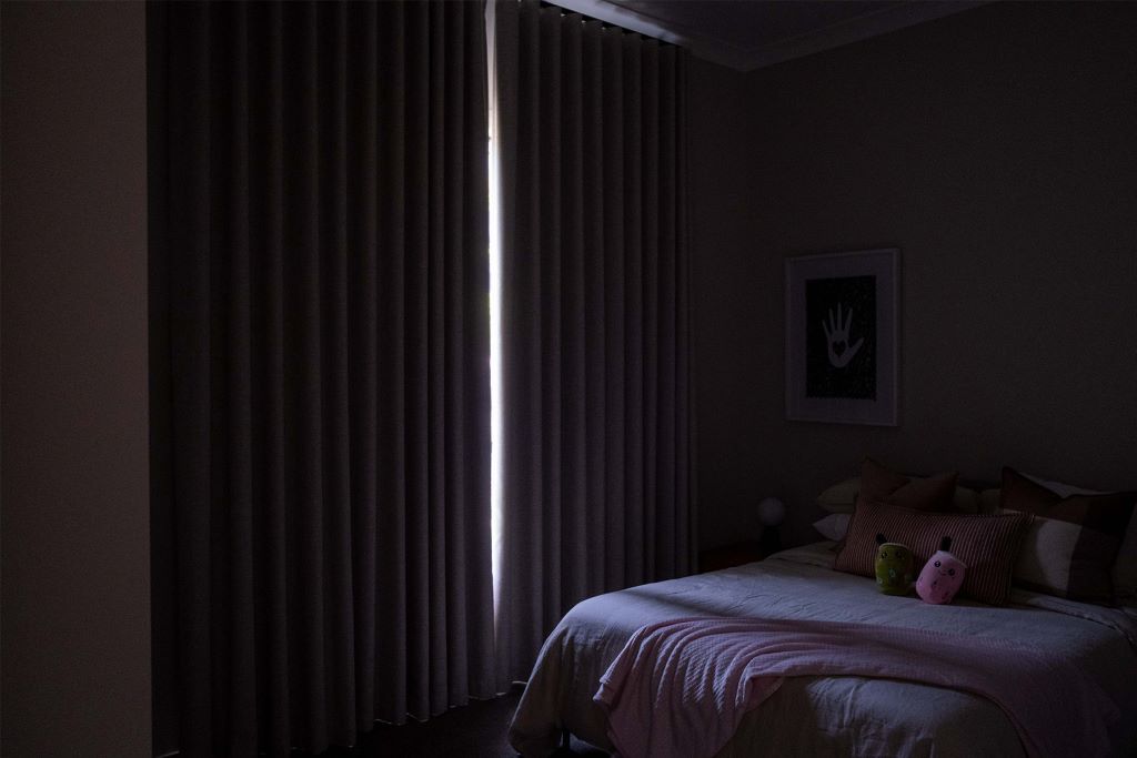 Modern bedroom with energy-efficient blackout curtains for comfort