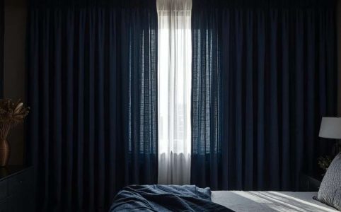 Blackout curtains keeping a bedroom cool during a sunny day