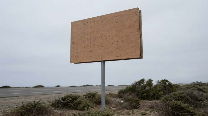 Outdoor business sign damaged by strong Dallas winds