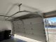 Technician inspecting low overhead garage door track alignment
