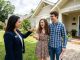 Young first-time home buyers in Alabama receiving keys to their new home