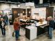 Visitors browsing kitchen remodeling booths at a fall home show