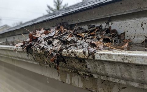 Seattle home gutters overflowing during heavy rain