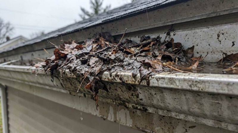Seattle home gutters overflowing during heavy rain