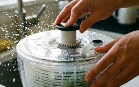 OXO salad spinner and a manual spinner displayed side by side on a counter.