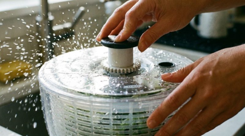 OXO salad spinner and a manual spinner displayed side by side on a counter.