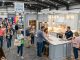Visitors browsing kitchen and remodeling displays at a Charleston home expo