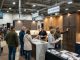 Visitors browsing kitchen cabinet displays at a Seattle home remodeling show